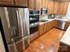 Kitchen with stainless steel appliances, wood floors, and wood cabinets at 7925 Woodmere Dr, Harrisburg, NC 28075