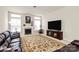 Living room featuring a fireplace, large TV, and a decorative area rug at 7925 Woodmere Dr, Harrisburg, NC 28075
