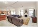 Bright living room with fireplace, brown leather sofa, and large area rug at 7925 Woodmere Dr, Harrisburg, NC 28075