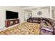 Living room with large brown leather sofa, TV, and decorative area rug at 7925 Woodmere Dr, Harrisburg, NC 28075