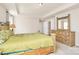 Spacious main bedroom featuring tray ceiling, dresser, windows and doors at 7925 Woodmere Dr, Harrisburg, NC 28075