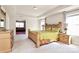 Spacious main bedroom featuring tray ceiling, dresser, windows and doorway into sitting area at 7925 Woodmere Dr, Harrisburg, NC 28075