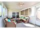 Bright sunroom featuring wicker furniture, ceiling fan and screened windows at 7925 Woodmere Dr, Harrisburg, NC 28075