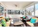 Inviting sunroom with wicker furniture, ceiling fan and an abundance of natural light at 7925 Woodmere Dr, Harrisburg, NC 28075