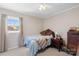 Cozy bedroom with neutral tones, a ceiling fan, and a window with natural light at 1912 Old West Ln, Gastonia, NC 28052
