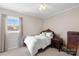 Neutral bedroom with white comforter, natural light, and classic wood furniture at 1912 Old West Ln, Gastonia, NC 28052
