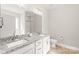 Bathroom featuring double sinks, granite countertops, and modern fixtures at 2116 Wilson Ave, Monroe, NC 28110