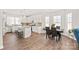 Open-concept kitchen and dining area with stainless steel appliances and an island with breakfast bar at 2116 Wilson Ave, Monroe, NC 28110