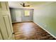 Bright bedroom featuring wood-look flooring, closet and an exit door at 417 Stonewall S Ave, Rock Hill, SC 29730
