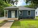 Charming renovated home featuring blue siding, a covered front porch, and a well-maintained lawn at 417 Stonewall S Ave, Rock Hill, SC 29730