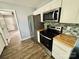 An eat-in kitchen area with wood-look floors and modern stainless steel appliances at 417 Stonewall S Ave, Rock Hill, SC 29730