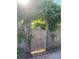 Wooden fence and gate covered in green vines with sunlight beaming through at 4519 S Potter Rd, Monroe, NC 28112