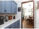 Modern kitchen with blue cabinets and white countertops that flows into the dining area at 4519 S Potter Rd, Monroe, NC 28112