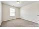 Bright, carpeted bedroom with a window offering natural light at 558 Dulaney Dr, Fort Mill, SC 29708