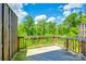 Wooden deck with lush greenery providing a serene outdoor space at 558 Dulaney Dr, Fort Mill, SC 29708