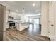 An open-concept kitchen features stainless steel appliances, gray cabinets, and an island with bar seating at 558 Dulaney Dr, Fort Mill, SC 29708