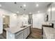 Bright kitchen featuring a central island with granite countertops and stainless-steel appliances at 558 Dulaney Dr, Fort Mill, SC 29708