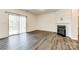 A bright living room features hardwood floors, a sliding door to the back deck, and a fireplace at 558 Dulaney Dr, Fort Mill, SC 29708