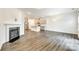 Spacious living room with fireplace open to the kitchen featuring an island and stainless steel appliances at 558 Dulaney Dr, Fort Mill, SC 29708