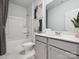 Clean and modern bathroom featuring a combination tub and shower, sleek vanity, and stylish decor at 1018 Mapletree Ln, Indian Trail, NC 28079