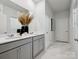Bathroom features double sinks, gray cabinets, white countertops, and stylish decor at 1018 Mapletree Ln, Indian Trail, NC 28079