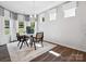 Cozy dining area with modern chairs, a stylish chandelier, and a plush rug at 1018 Mapletree Ln, Indian Trail, NC 28079