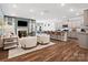 Open-concept living space with a fireplace, kitchen, dining area, and comfortable seating at 1018 Mapletree Ln, Indian Trail, NC 28079