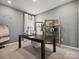 Stylish home office with a desk, shelving, and natural light, ideal for remote work at 1018 Mapletree Ln, Indian Trail, NC 28079
