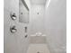 Tiled shower with a built-in bench, niche, and chrome fixtures at 1018 Mapletree Ln, Indian Trail, NC 28079