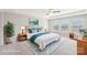 Serene primary bedroom features a tray ceiling, neutral carpet, two windows, with blue decor at 1034 Currituck Way, York, SC 29745