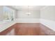 Elegant dining room with wainscoting, hardwood flooring, and natural light from a large window at 1034 Currituck Way, York, SC 29745