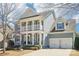 Charming two-story home with a double-door garage, columns, and a welcoming front porch with American Flag at 1034 Currituck Way, York, SC 29745