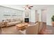 Cozy living room with a fireplace, neutral furnishings, hardwood floors, and natural light at 1034 Currituck Way, York, SC 29745