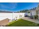 Private backyard boasts a patio, white fence, and low maintenance artificial turf at 104 S Canyon Rdg, Mount Holly, NC 28120