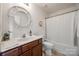 Bright bathroom features a decorative circular mirror and a shower-tub combo at 104 S Canyon Rdg, Mount Holly, NC 28120