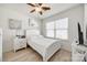 Bedroom showcasing white walls, ceiling fan, and a window that allows natural light into the room at 104 S Canyon Rdg, Mount Holly, NC 28120