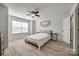 Bright bedroom with light-colored walls, ceiling fan, and natural light from the large window at 104 S Canyon Rdg, Mount Holly, NC 28120