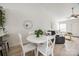 Dining area featuring a charming white table, seating for four, and bright lighting at 104 S Canyon Rdg, Mount Holly, NC 28120