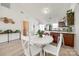 Open-concept dining area with kitchen view, sleek floors, and modern design at 104 S Canyon Rdg, Mount Holly, NC 28120