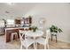 Dining area featuring a charming white table, seating for four, and kitchen view at 104 S Canyon Rdg, Mount Holly, NC 28120
