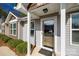 Welcoming entrance featuring a modern glass storm door and landscaped surroundings at 104 S Canyon Rdg, Mount Holly, NC 28120