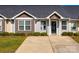 Charming home featuring manicured front yard, driveway, and inviting entryway at 104 S Canyon Rdg, Mount Holly, NC 28120