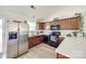 Well-lit kitchen featuring stainless steel appliances, wood cabinets, and white countertops with plant decorations at 104 S Canyon Rdg, Mount Holly, NC 28120