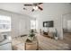 Open-concept living room with lots of light, modern décor, and wood-look floors at 104 S Canyon Rdg, Mount Holly, NC 28120