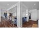 Stylish wet bar with seating, wood floors, and sophisticated design details at 111 Moors End Loop, Mooresville, NC 28117