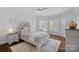 Bright bedroom with neutral colors, and a serene lake view from the windows at 111 Moors End Loop, Mooresville, NC 28117