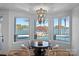 Bright dining area with lake views, elegant chandelier, and seating for six at 111 Moors End Loop, Mooresville, NC 28117