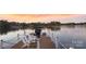 Cozy waterfront dock with seating and beautiful lake view at sunset at 111 Moors End Loop, Mooresville, NC 28117
