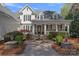 Charming home featuring a fountain, meticulous landscaping, and a classic covered front porch at 111 Moors End Loop, Mooresville, NC 28117