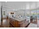 Gourmet kitchen featuring a large island with granite countertops, farm sink, and an open design to the living room and dining area at 111 Moors End Loop, Mooresville, NC 28117